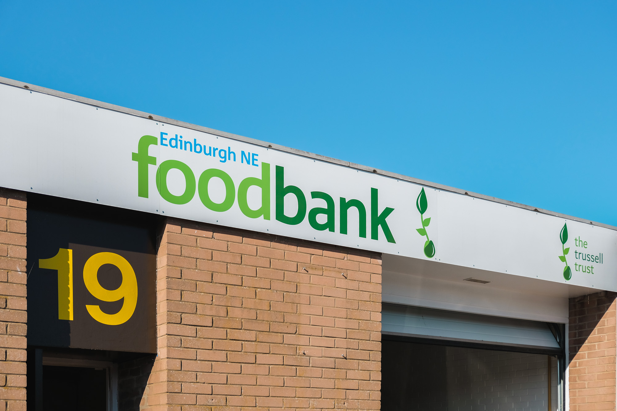 Outdoor sign for Edinburgh NE foodbank at number 19